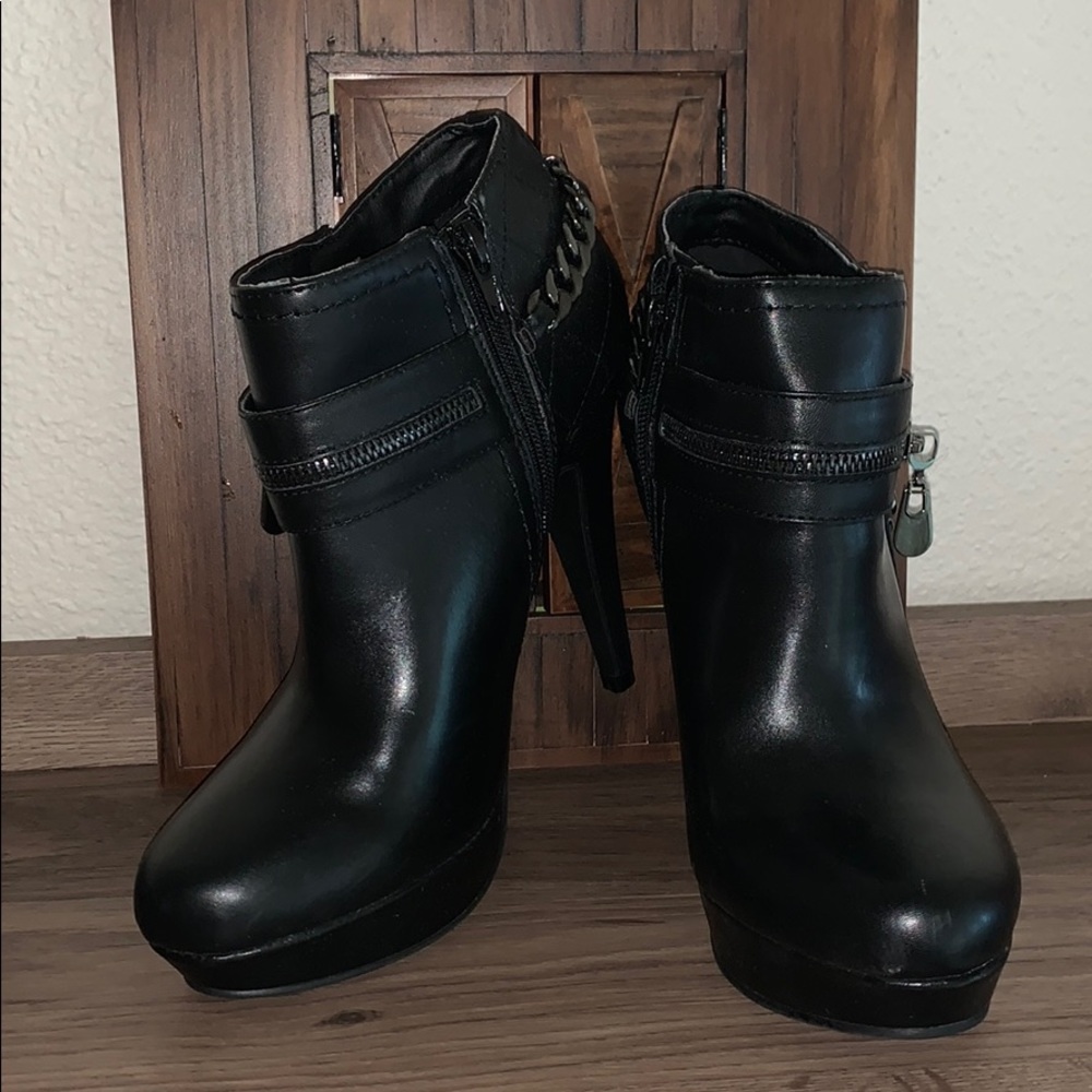 G by Guess black high heel boots.